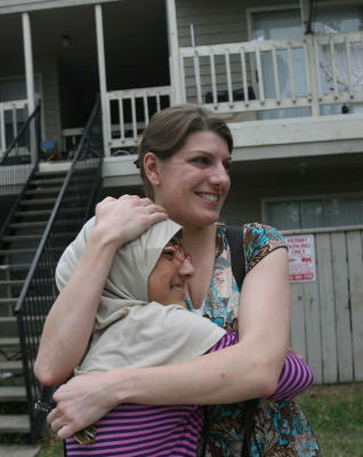 Marzia Bostani, 11, says goodbye Thursday to Liz Valette outside the Afghan refugee’s southwest Houston apartment. The 31-year-old former Army captain spent a year in Iraq, and now is heading to Afghanistan to work as a humanitarian aid worker