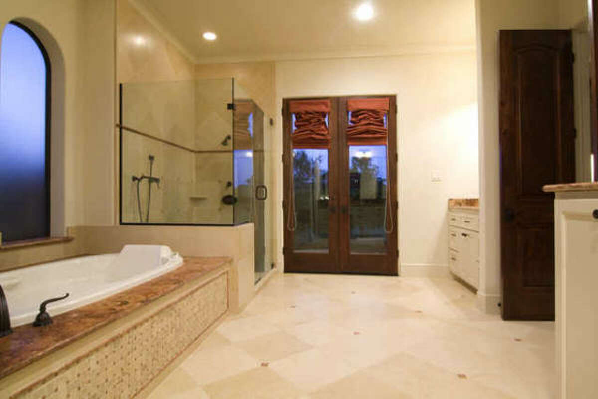Master bathrooms that have a separate shower and bathtub, like the one in this Royal Oaks home, are in demand for 2010, according to builders.