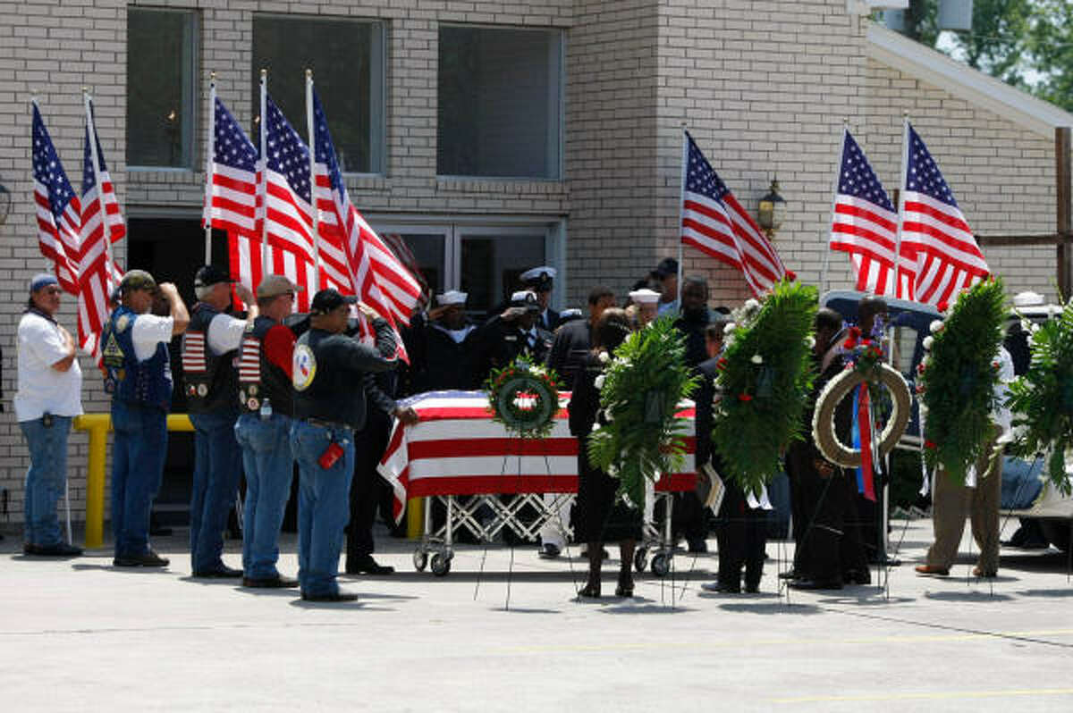 The casket of U.S. Navy sailor August Provost III leaves the Wright Grove Baptist Church in the Acres Home area on Friday. The Navy is still investigating the death of the 29-year-old, who was openly gay. Some say his death was a hate crime.