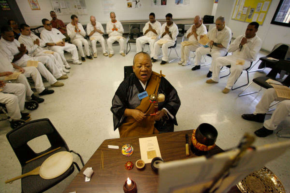 Nichiren Buddhist priest Myokei Caine-Barrett, 58, of Houston leads a group of inmates at the Texas Department of Criminal Justice's Pack Unit near Navasota. Each Friday and the occasional Sunday, Caine-Barrett leads her 21-member congregation in chants and meditation as well as preaching sermons.