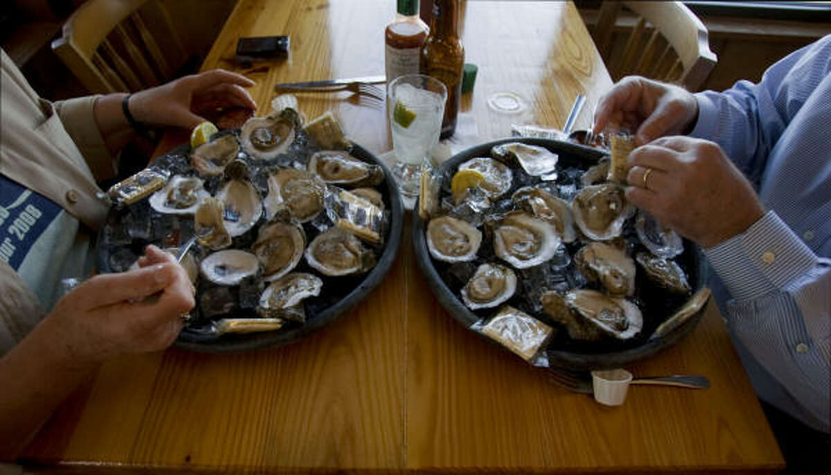 GOOD FOOD: Patrons eat oysters for lunch at Stingaree Restaurant, an iconic eatery on Crystal Beach.﻿