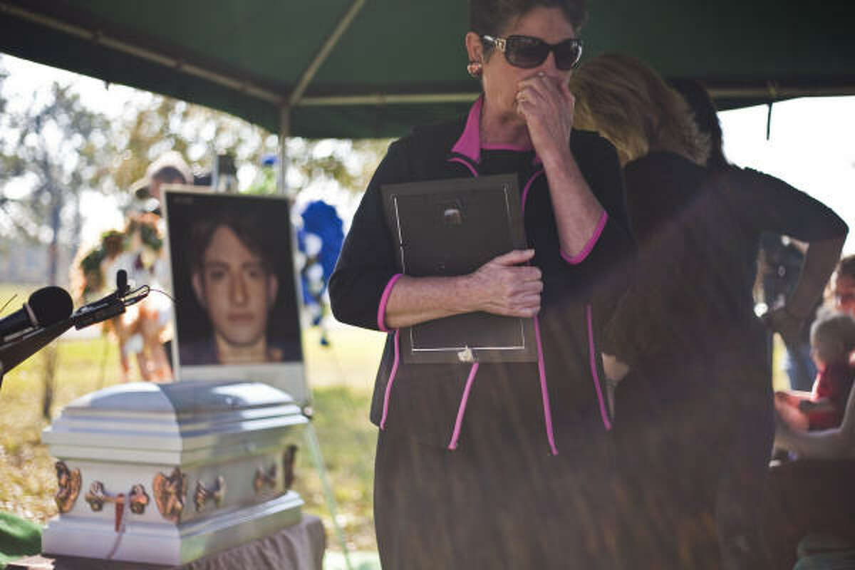 Cindi Michalk pays her respects Thursday at services for one of 1970s serial killer Dean Corll's unnamed victims. The portrait shows how “Swimming Suit Boy” might have looked.
