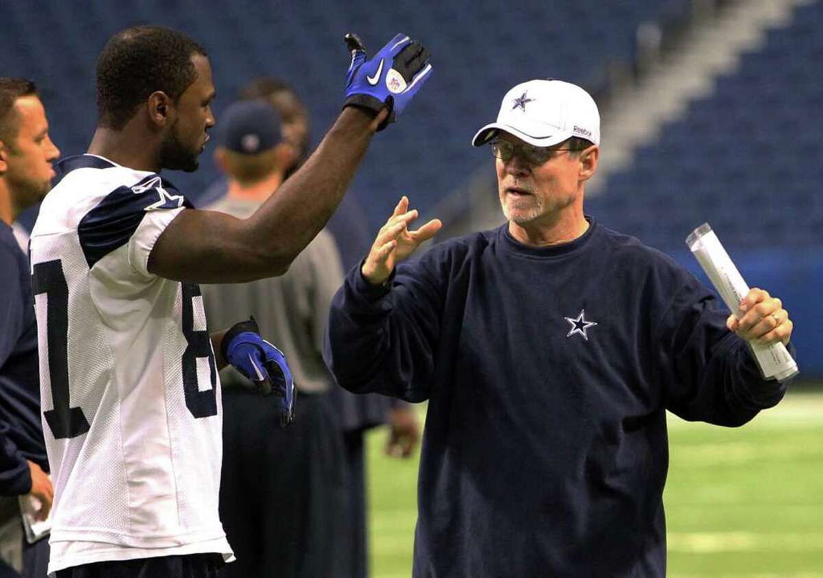 Wide receivers coach Jimmy Robinson (right) talks with receiver Titus Ryan (87) near the end of the morning session of the Dallas Cowboys training camp at the Alamodome on Thursday, Aug. 4, 2011. Robinson was involved in a collision with a player last week which caused him to be taken to the hospital and out of work for several days. Kin Man Hui/kmhui@express-news.net