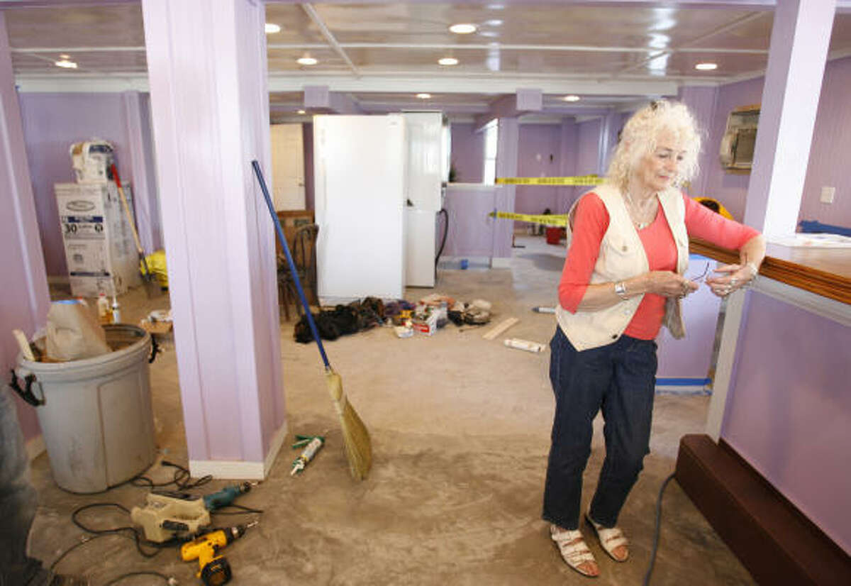 Bonnie “Kitty” Smith stands in the bar area at Kitty’s Purple Cow in Surfside on Thursday. The bar-restaurant was destroyed by Hurricane Ike, and Smith has been working for the past two months on getting the business ready to reopen today.