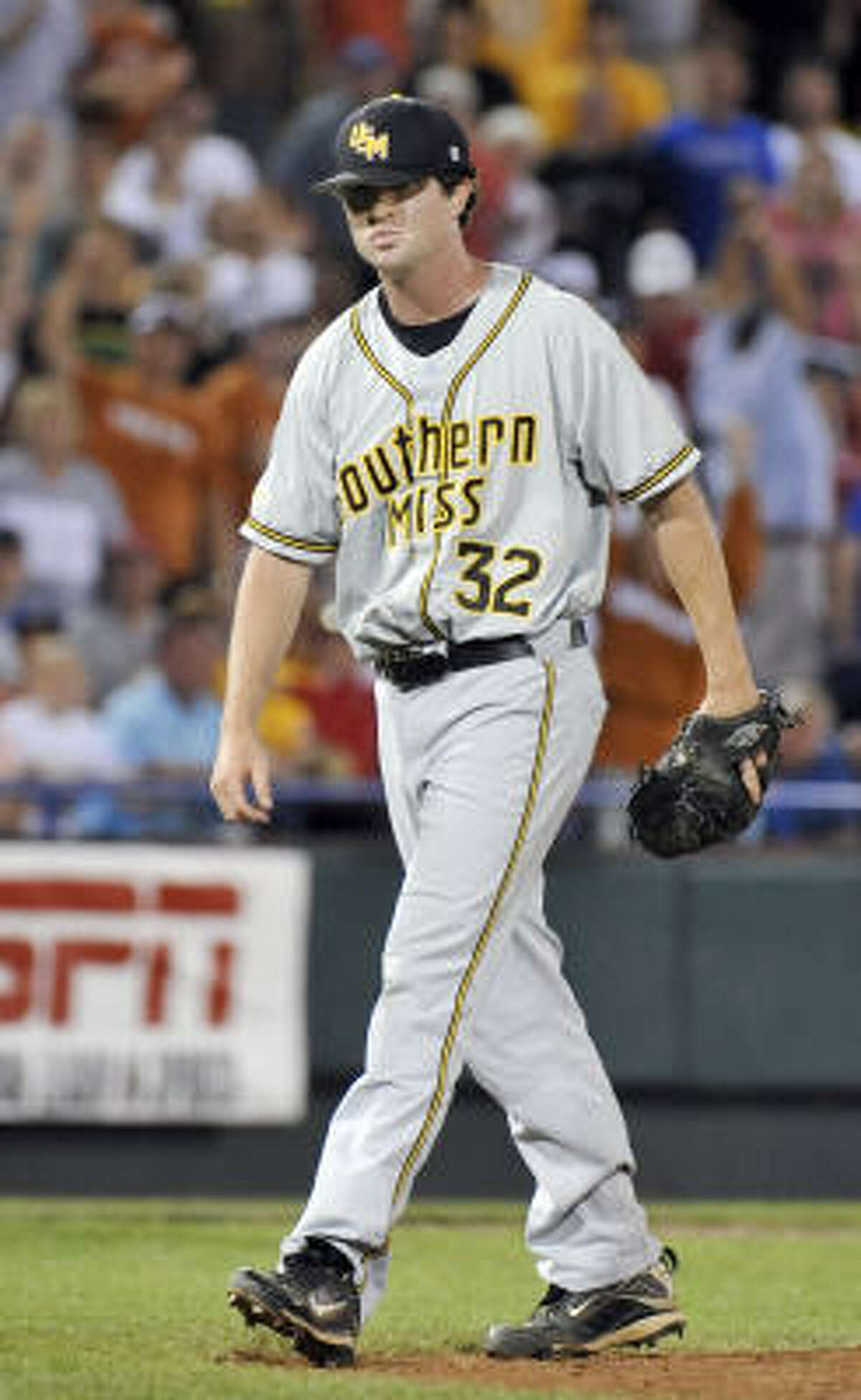 Southern Mississippi pitcher Jonathan Johnston walks off the field after walking Texas' Brandon Loy in the ninth inning.