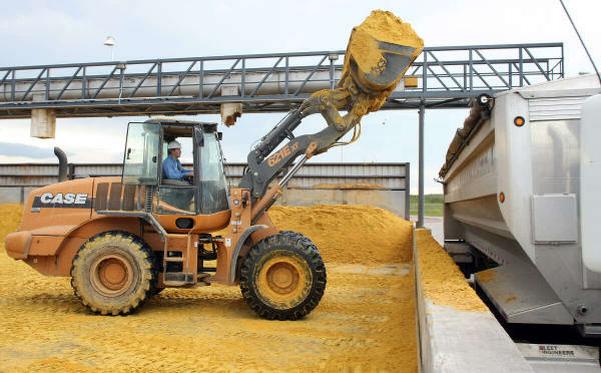 A heavy equipment operator at Valero's newly acquired corn ethanol plant in Hartley, Iowa, loads a trailer truck with modified distiller's grain left after ethanol processing.