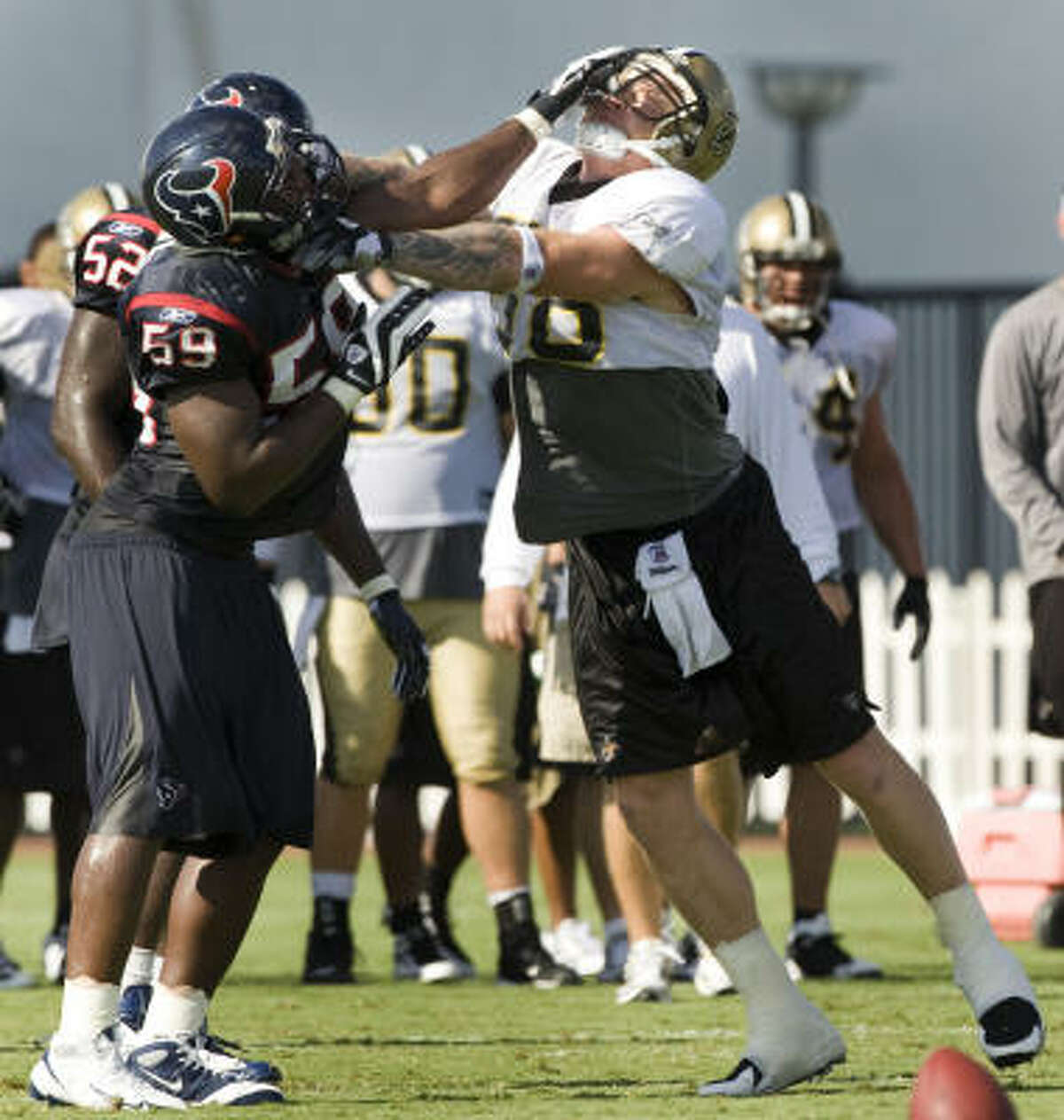 Texans linebacker DeMeco Ryans and New Orleans Saints tight end Jeremy Shockey get into a fight during Thursday's morning workout.