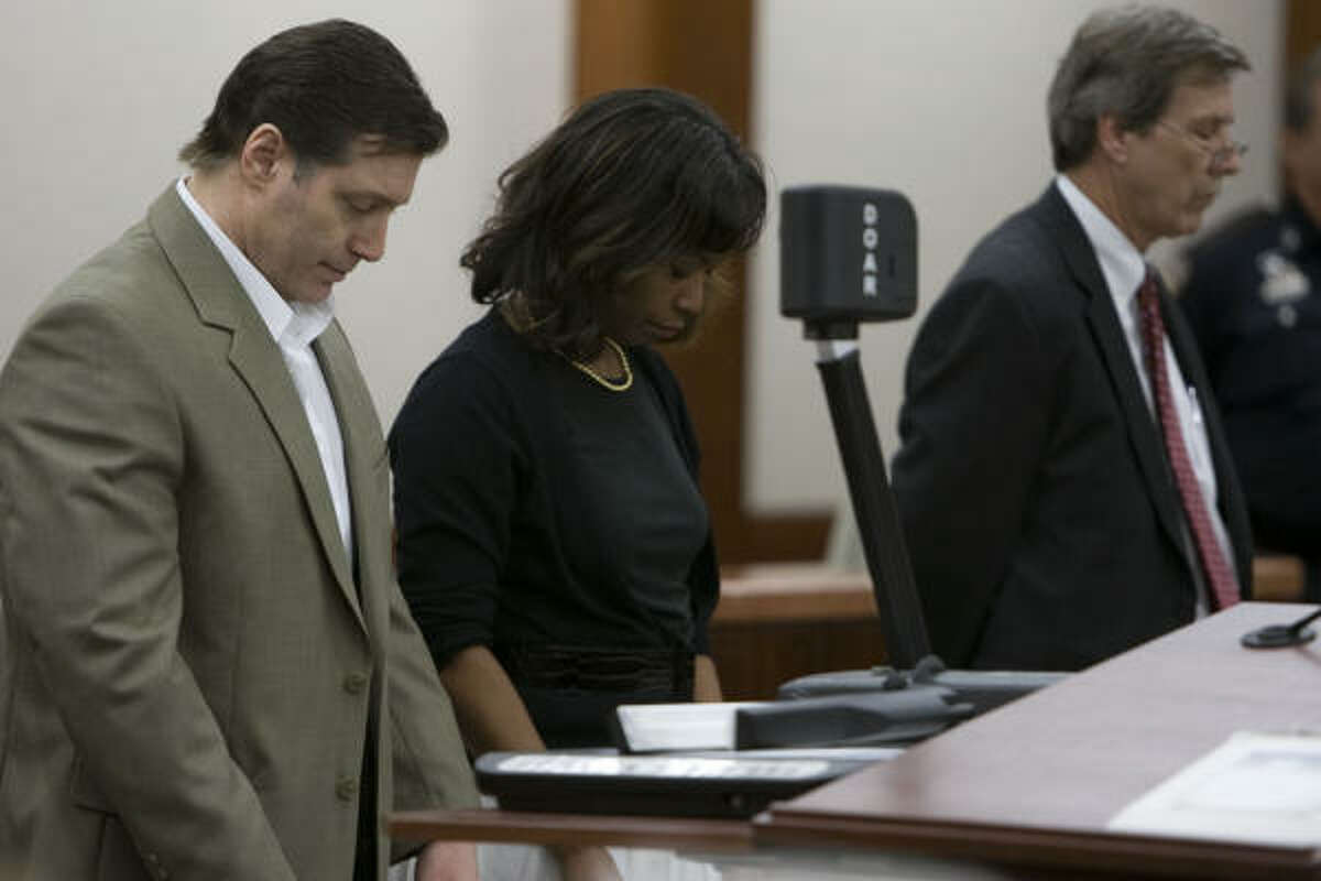 Robert Fratta, left, stands with his lawyers, Vivian King and Randy McDonald, as the decision is read Saturday.