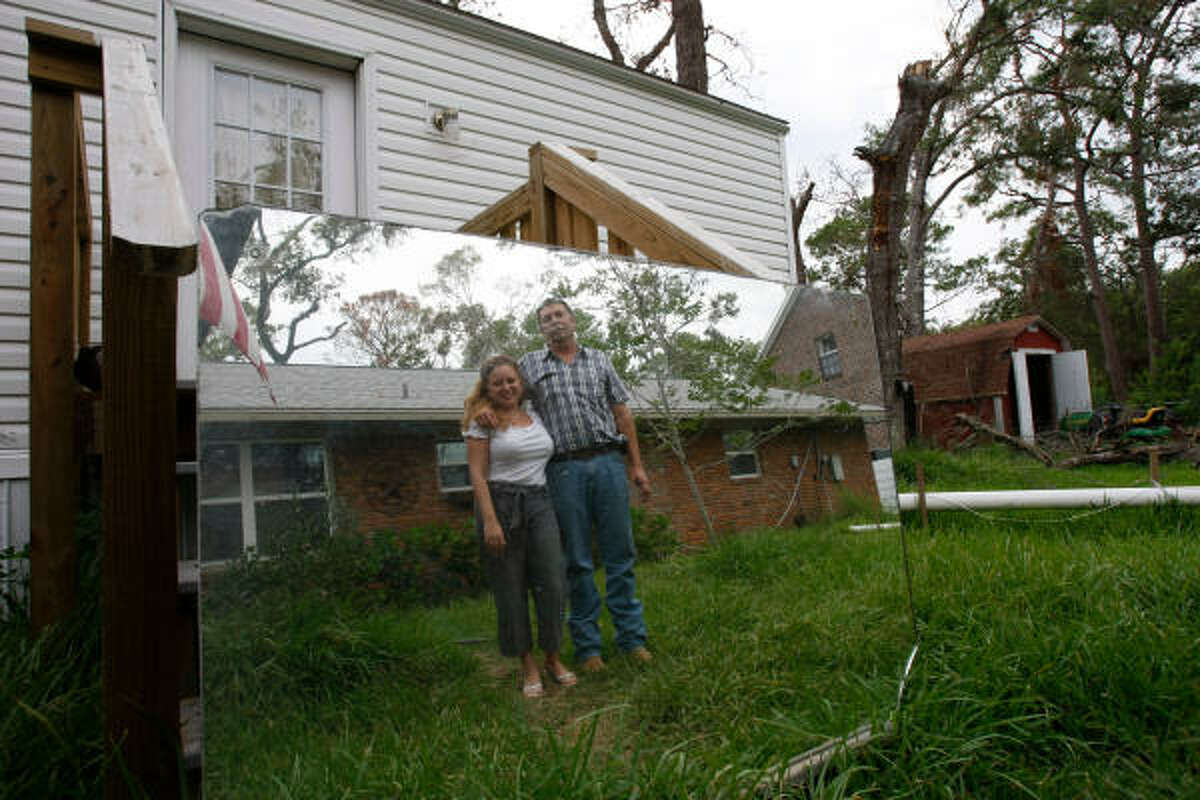 Dennis and Angela McClung have been living in this FEMA trailer in their yard while they refurbish their Shoreacres home, shown in the mirror's reflection.﻿