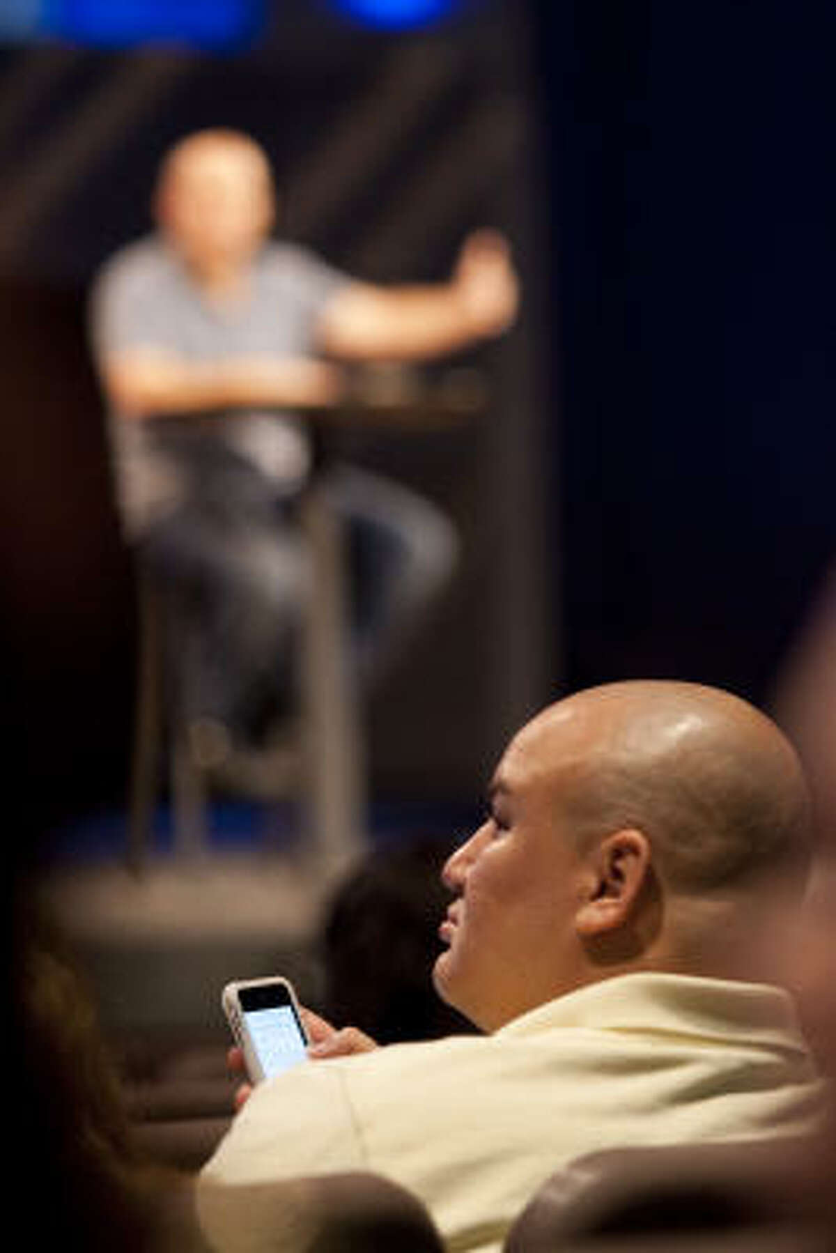 Pimentel's iPhone becomes a part of the Sunday evening service earlier this month at Woodlands Church. “Using all these resources that we have, like Facebook and Twitter, to get closer to the pastor is great; it's awesome,” Pimentel says.﻿