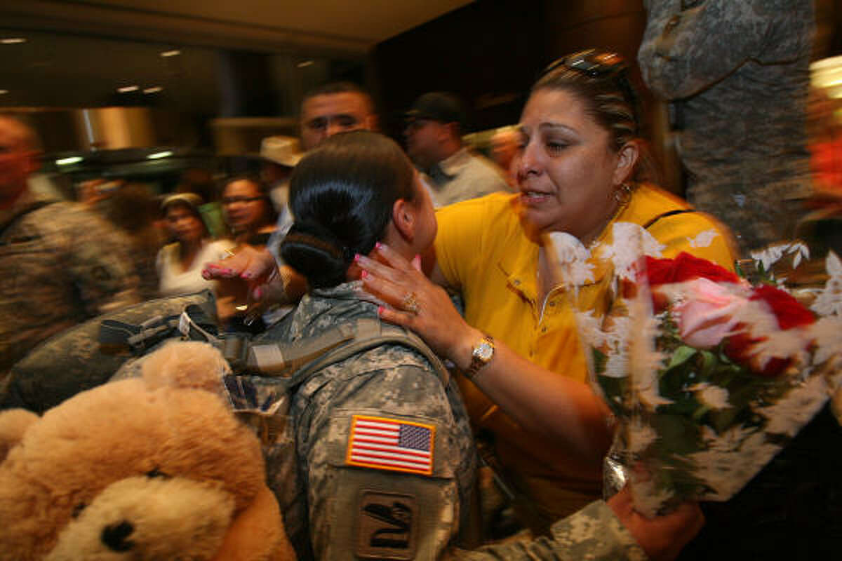 Pfc. Cassandra Mendoza, 19, is embraced by her mother, Veronica Soto, after Mendoza's Baytown-based Texas National Guard unit arrived home after almost a year in Iraq.