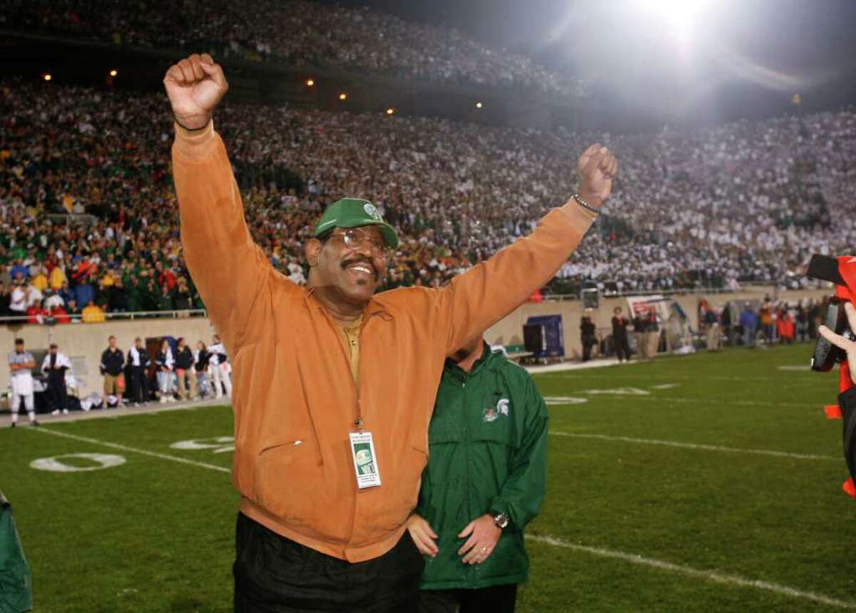 In this September 2006 photo provided by Michigan State University, former Michigan State football player Bubba Smith raises his arms during a ceremony at which his jersey number was retired, in East Lansing, Mich. Smith, a former NFL defensive star who found a successful second career as an actor, died Wednesday, Aug. 3, 2011, in Los Angeles at age 66. Los Angeles County coroner's spokesman Ed Winter said Smith was found dead at his Baldwin Hills home. Winter said he didn't know the circumstances or cause of death. (AP Photo/Michigan State University)