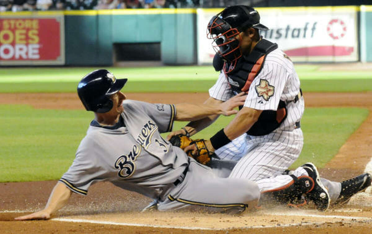 The Brewers' Craig Counsell, left, is tagged out at the plate by Astros catcher Ivan Rodriguez.
