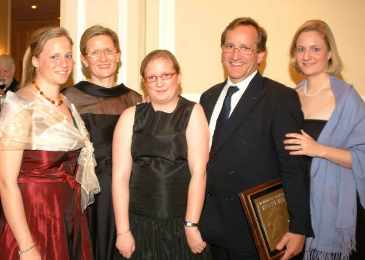 SAY CHEESE: Philippe Cras poses with his family: daughter Evelyne, 17, left, wife Mieke, and daughters Pauline, 15, and Nathalie, 19. The Belgium native was named the Humble Chamber’s Citizen of the year at an awards ceremony Feb. 27.