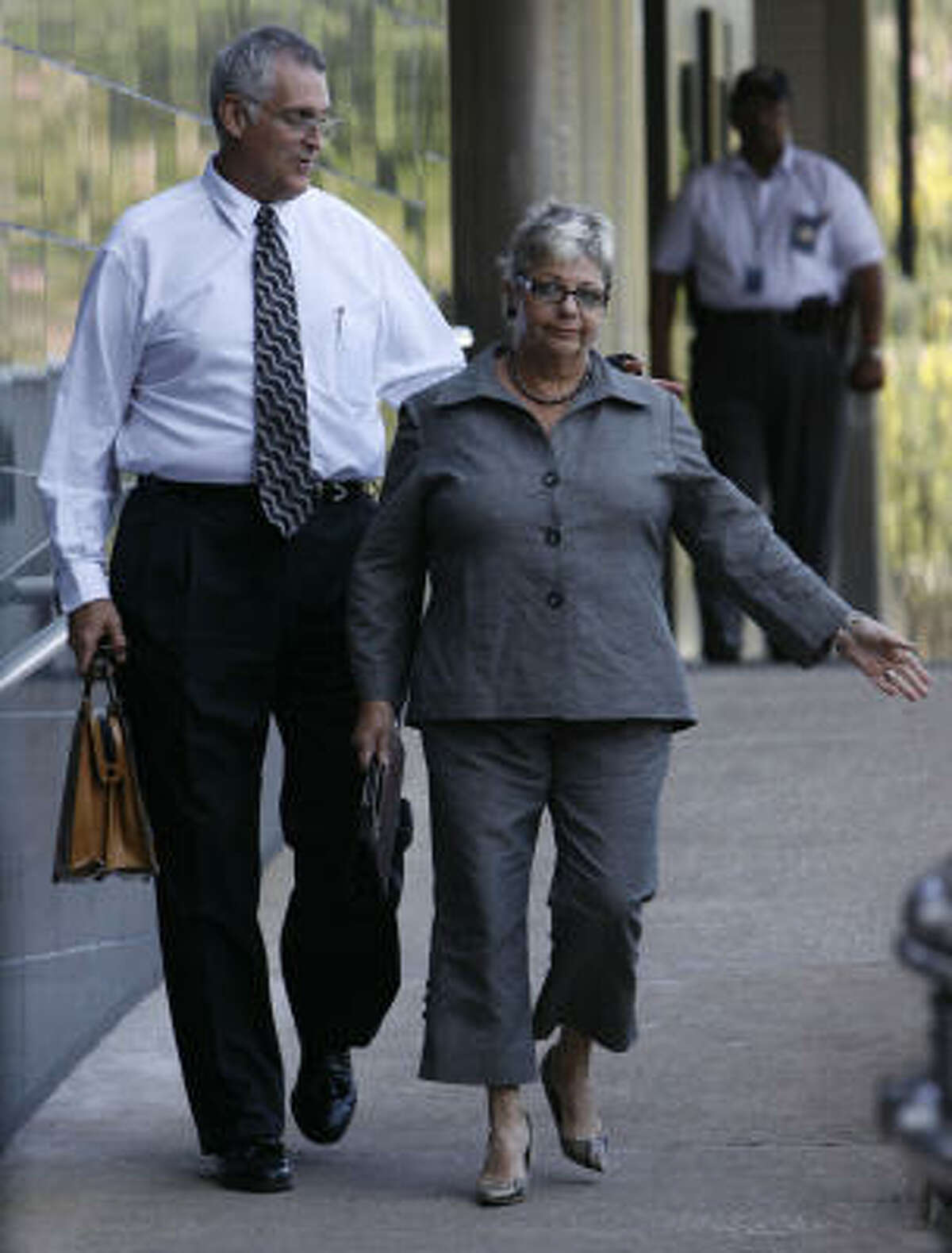 U.S. District Judge Samuel Kent walks out of the Bob Casey Federal Courthouse with his wife, Sarah, on Sept. 3. Kent is scheduled to be arraigned on the new charges Wednesday morning. His trial on the first sexual charges is set for Jan. 26 before U.S. Senior Judge Roger Vinson, of Florida, who is overseeing the case.