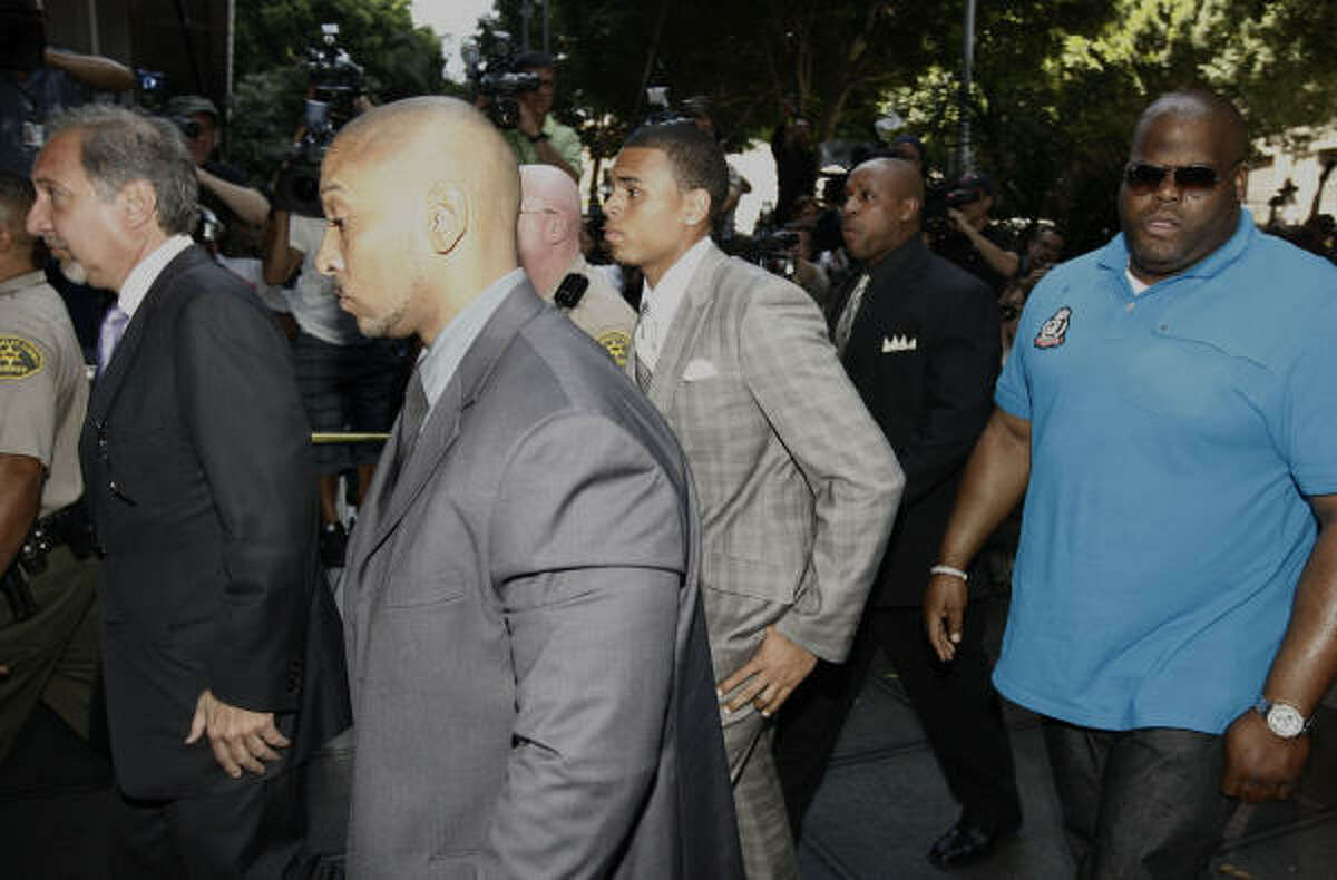 Chris Brown, center, pleaded guilty to one count of felony assault on pop star Rihanna.