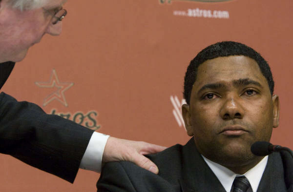 Astros shortstop Miguel Tejada pauses, as his attorney Mark Tuohey touches his shoulder, as Tejada offers an apology for lying to congress during a news conference at Minute Maid Park on Wednesday.