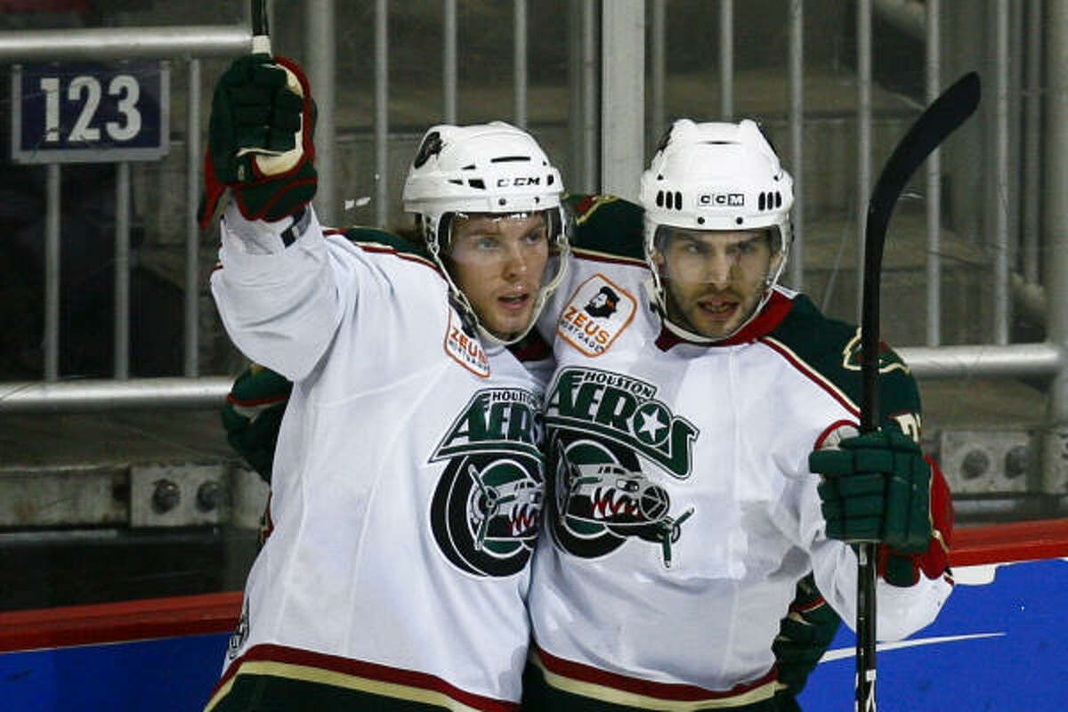 The Aeros’ Corey Locke, left, celebrates his second-period goal with Matt Beaudoin, who assisted on the score.