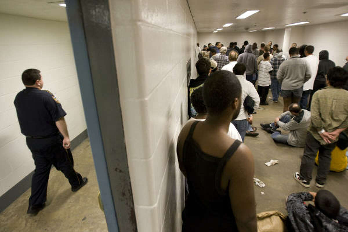Men crowd a holding cell last week. “We need more space,” said Lt. Michael Lindsay. “Many are bad guys, but they are human beings, and we don’t want to treat them like cattle.”