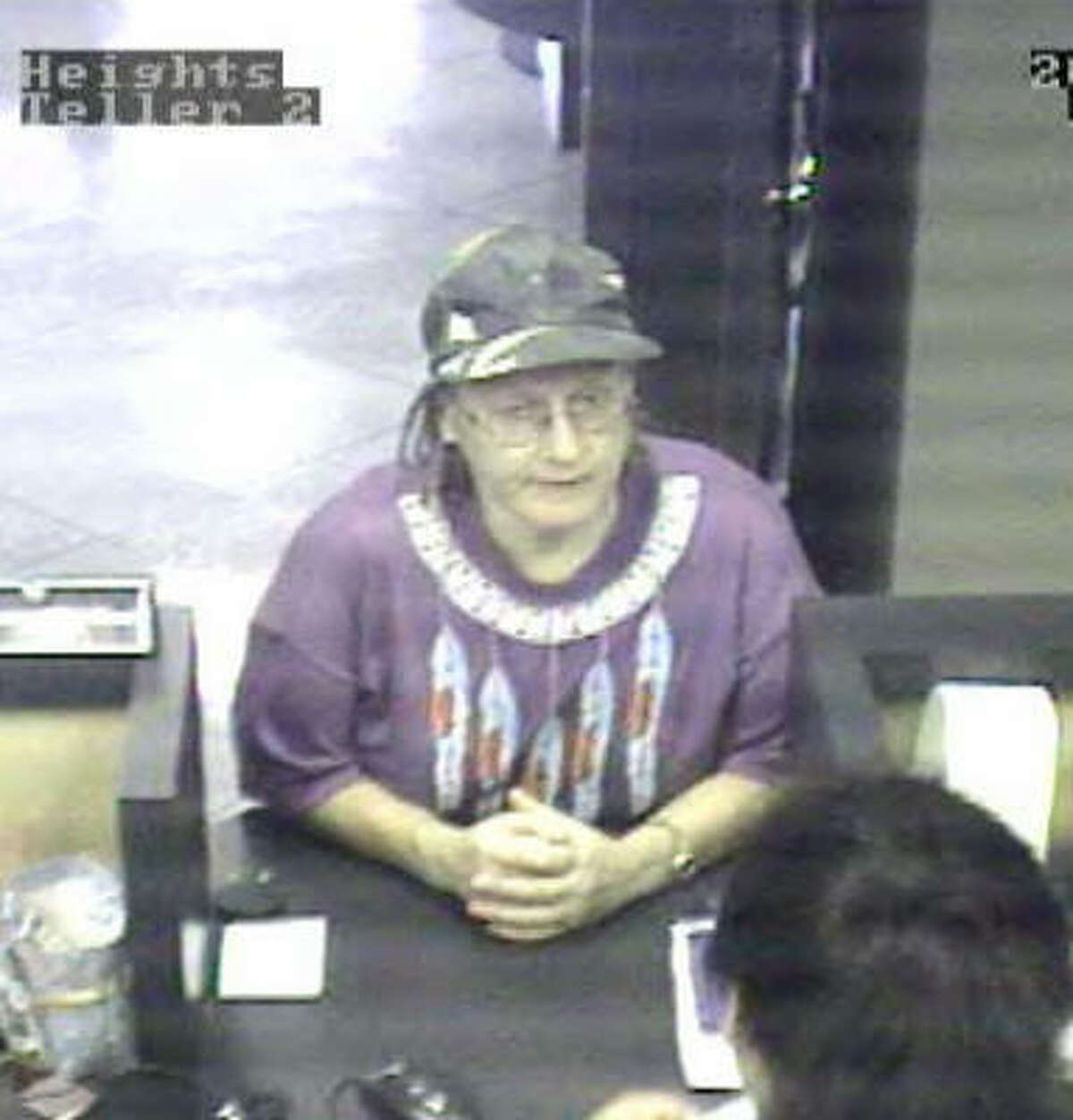 Image from a surveillance camera shows a bank robber authorities have dubbed the "Grandma Bandit." She struck two Compass Bank branches in Houston on Friday.