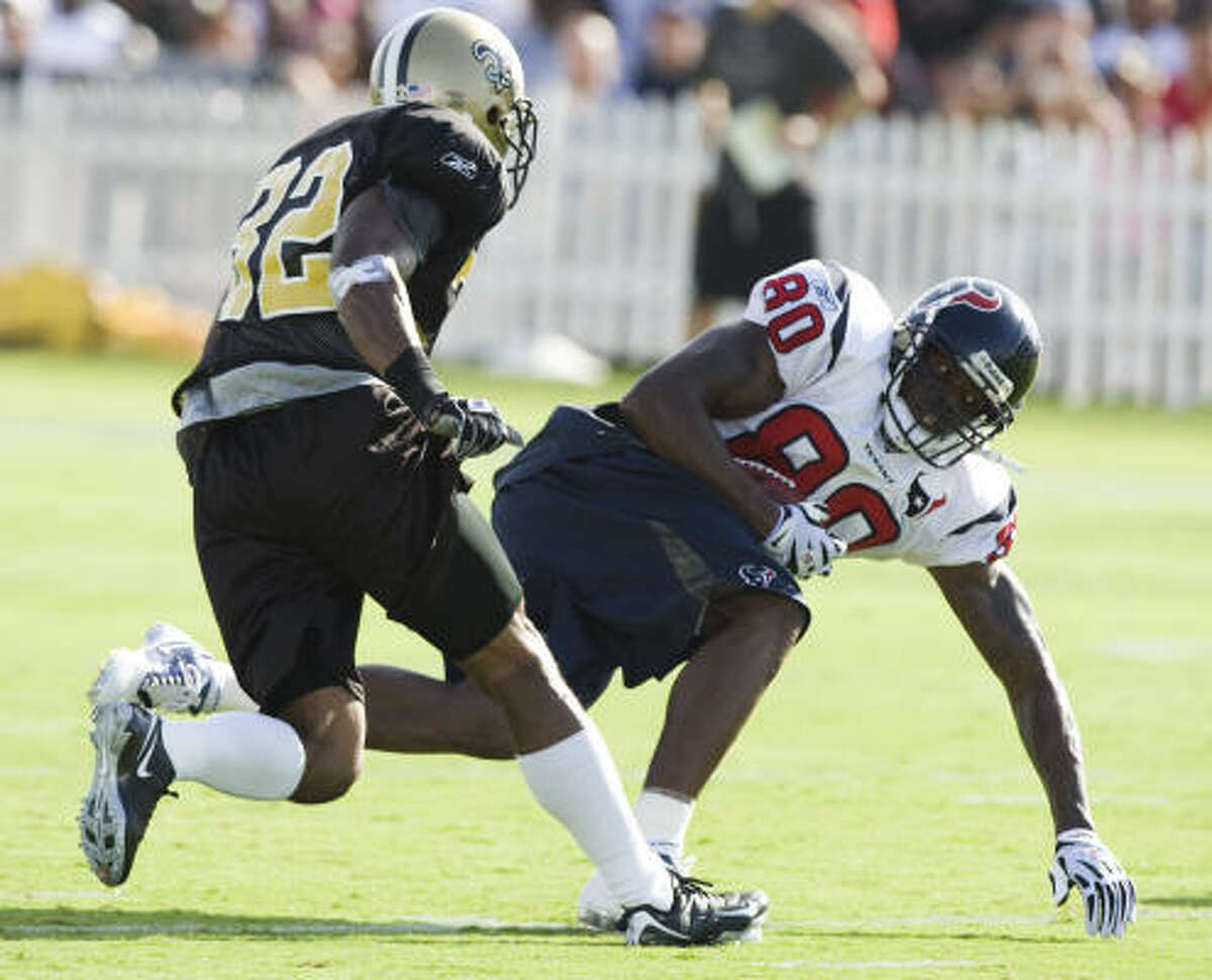 Texans wide receiver Andre Johnson catches a ball in front of New Orleans Saints cornerback Jabari Greer.
