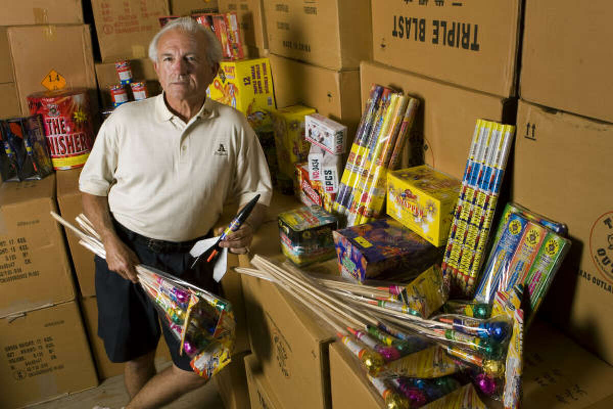 Texas' fireworks laws have become contentious. Here Paul Dewey Jones poses at his store last week.