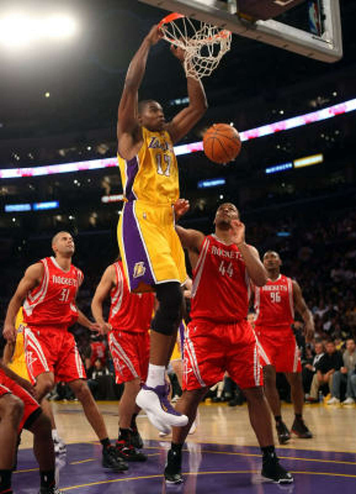 Andrew Bynum, shown dunking alongside Rockets defender Chuck Hayes, started and scored 14 points and grabbed six rebounds in the Lakers’ 118-78 win that put them with one win of eliminating the Rockets.