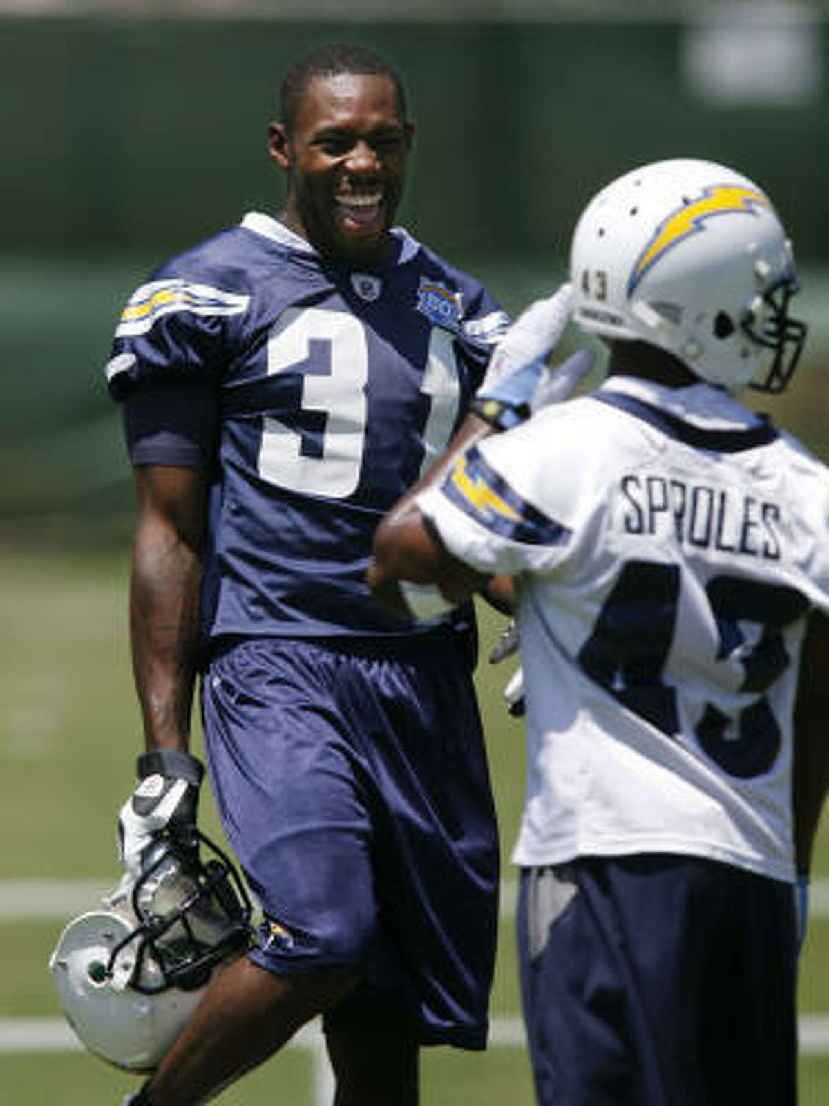 Chargers corner Antonio Cromartie laughs as he talks with Darren Sproles during their training camp held at the Chargers facility in San Diego.