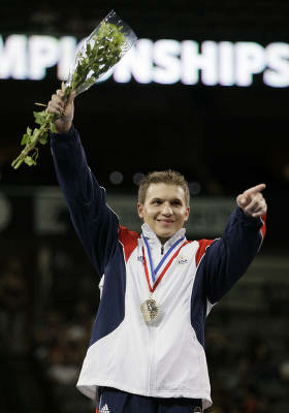 Jonathan Horton reacts to cheers from the crowd during the award ceremony following the the U.S. gymnastics championships Friday in Dallas. Horton was the all-around winner.