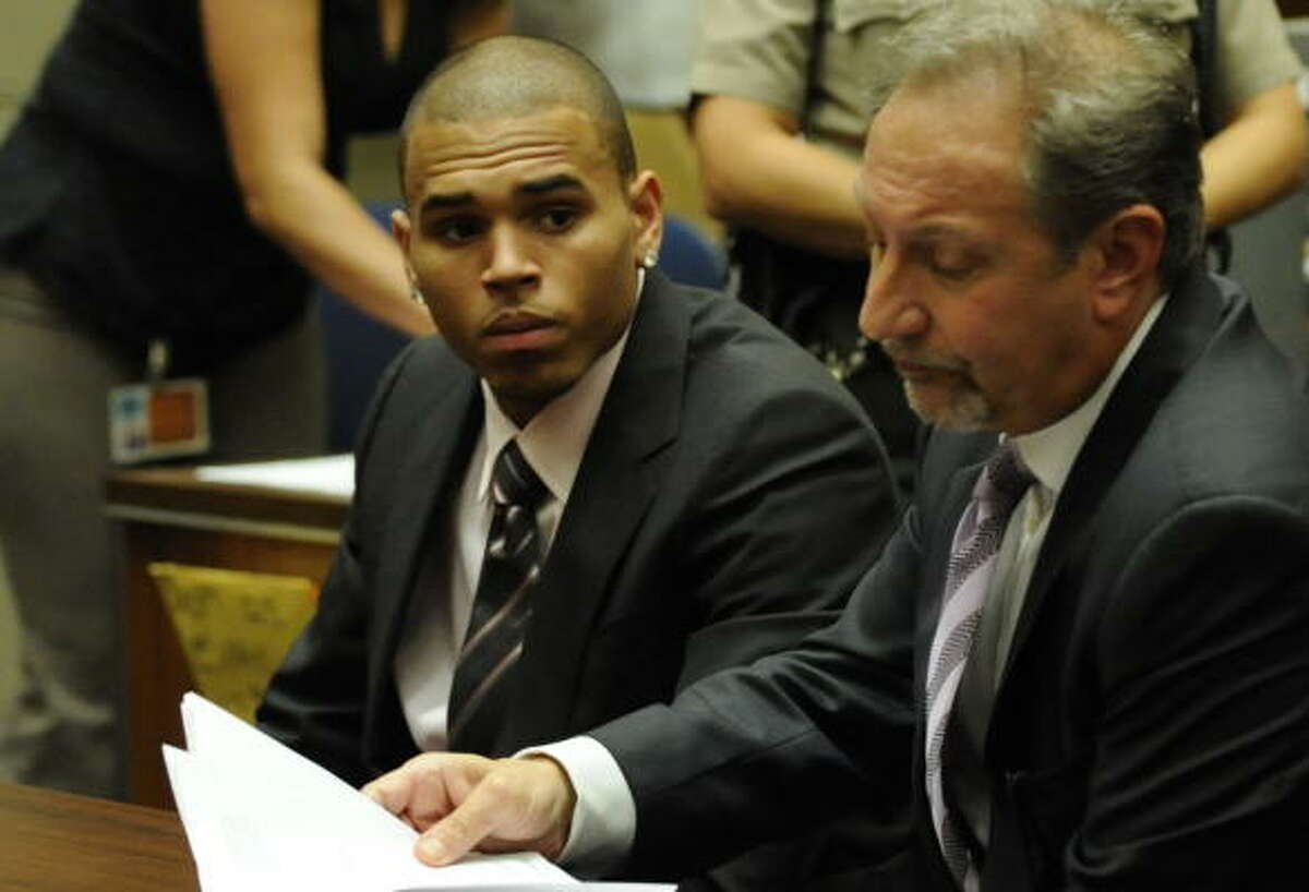 R&B singer Chris Brown (L) sits beside his attorney Mark Geragos (R) at his sentencing at Los Angeles Superior Court on August 5, 2009. Brown's pleaded guilty in June to a felony assault charge for beating up his ex-girlfriend Rihanna. The sentencing was continued until August 27.