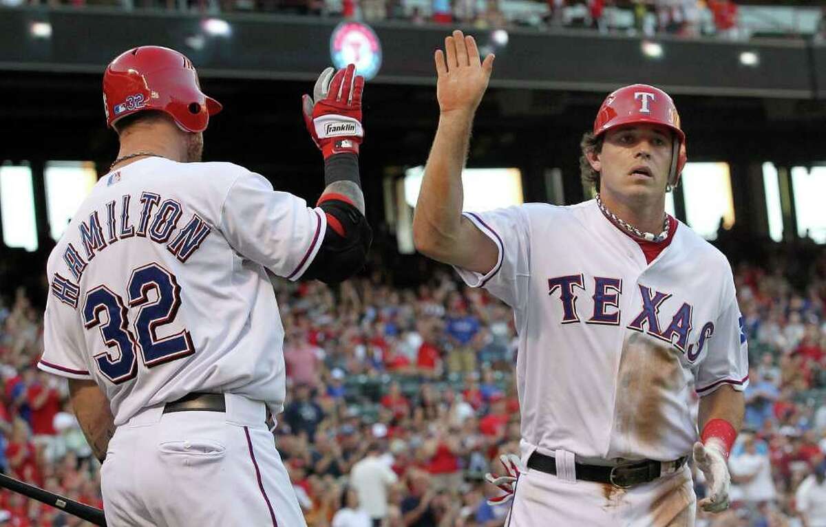 Josh Hamilton and Ian Kinsler celebrate during the Texas Rangers’ 8-7, 11-inning victory over the Cleveland Indians on Friday.