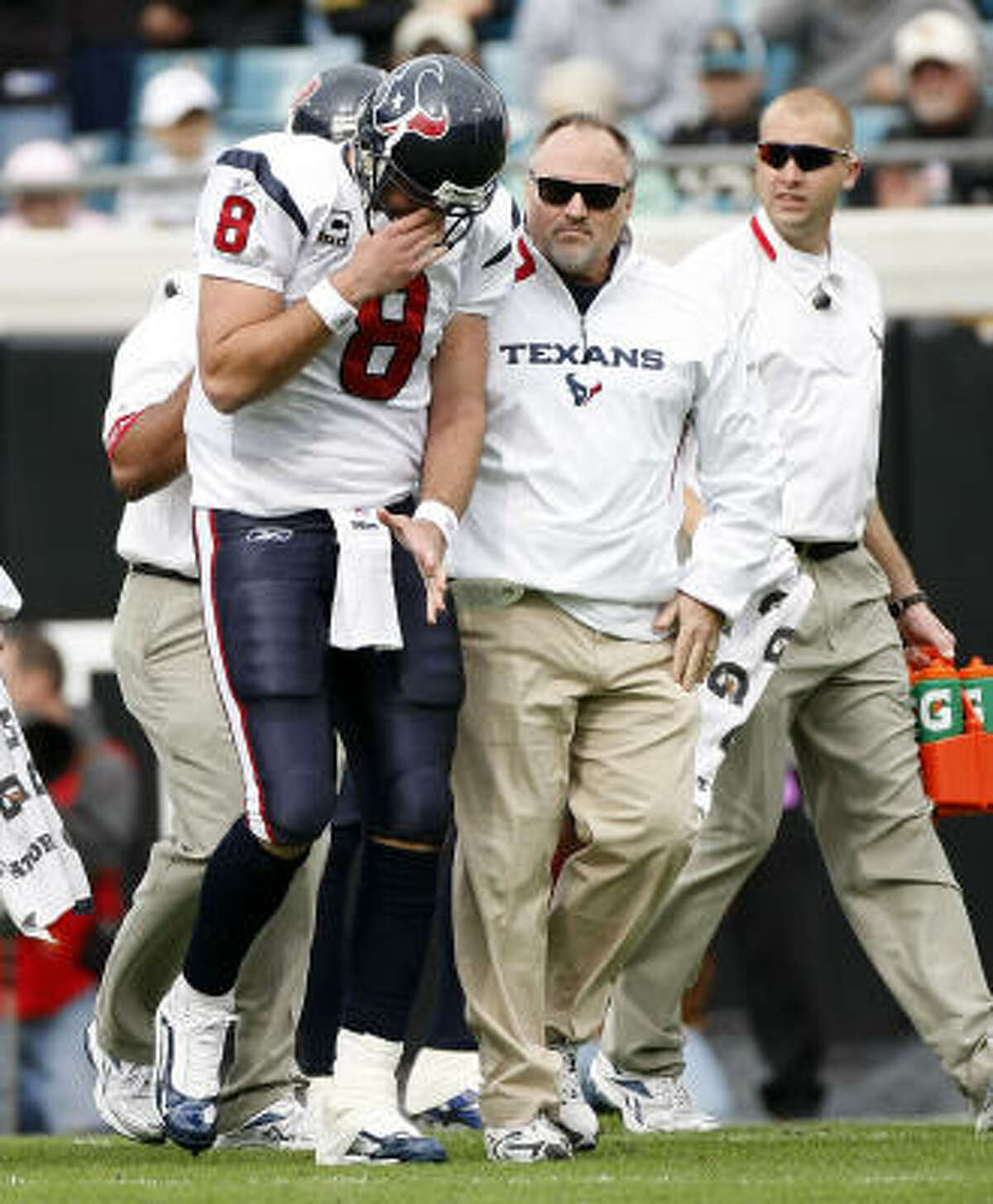 Texans quarterback Matt Schaub leaves the field after dislocating his left shoulder on the Texans' first offensive play. Schaub returned to the game in the second quarter.