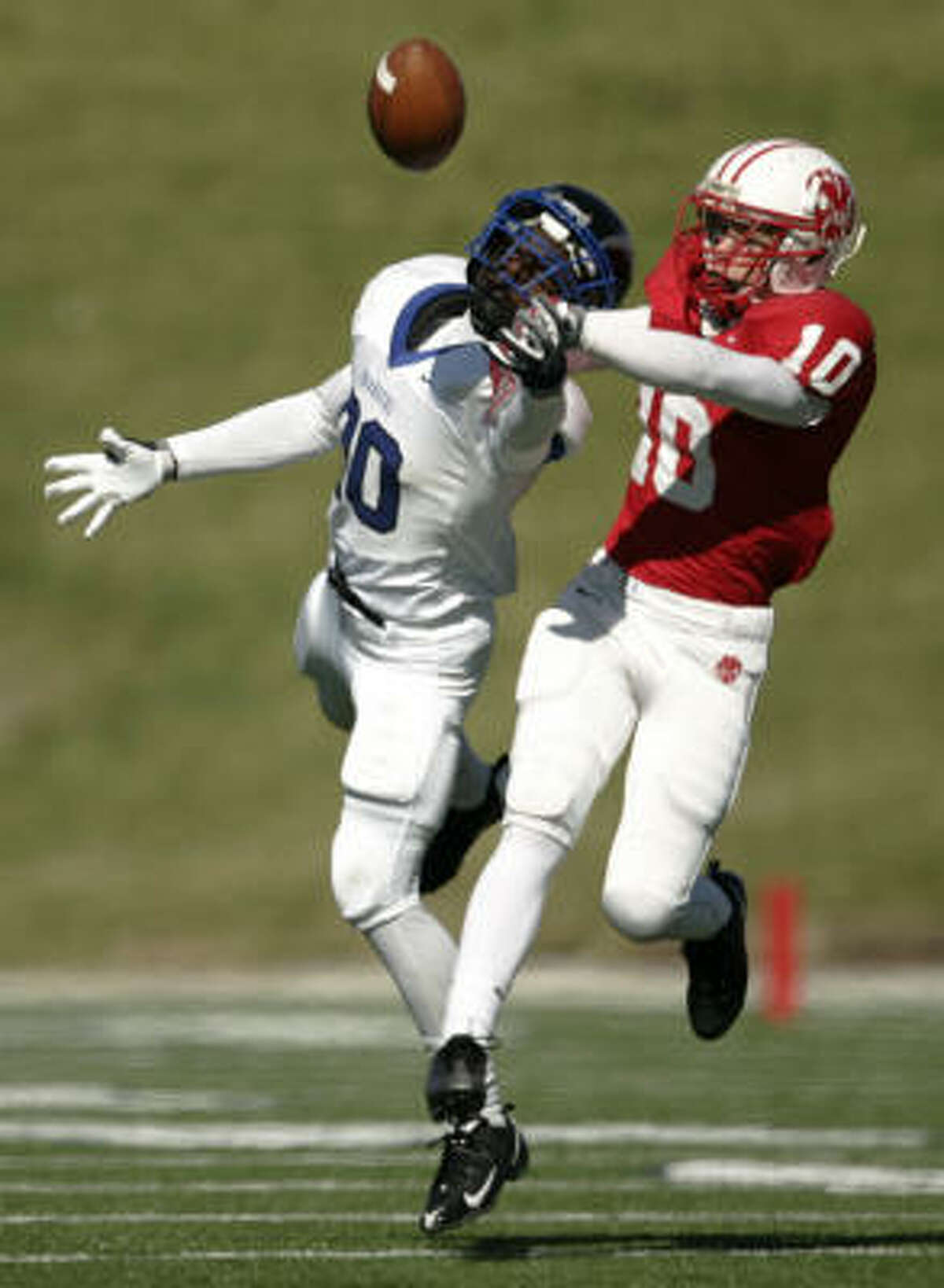 Katy's Channing Pate (left) breaks up a pass intended for Clear Springs' Dimitri Donals.