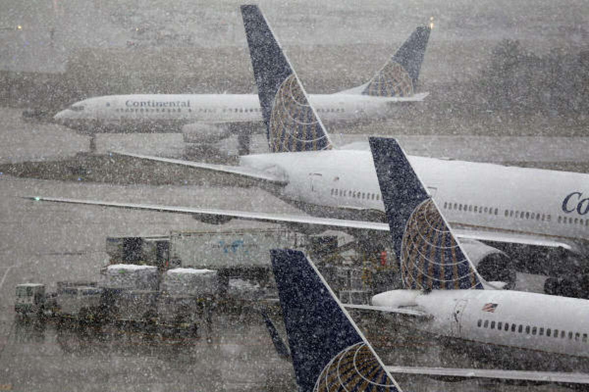 Snow falls at Bush Intercontinental Airport on Friday. Several flights were canceled at both Bush and Hobby Airport.