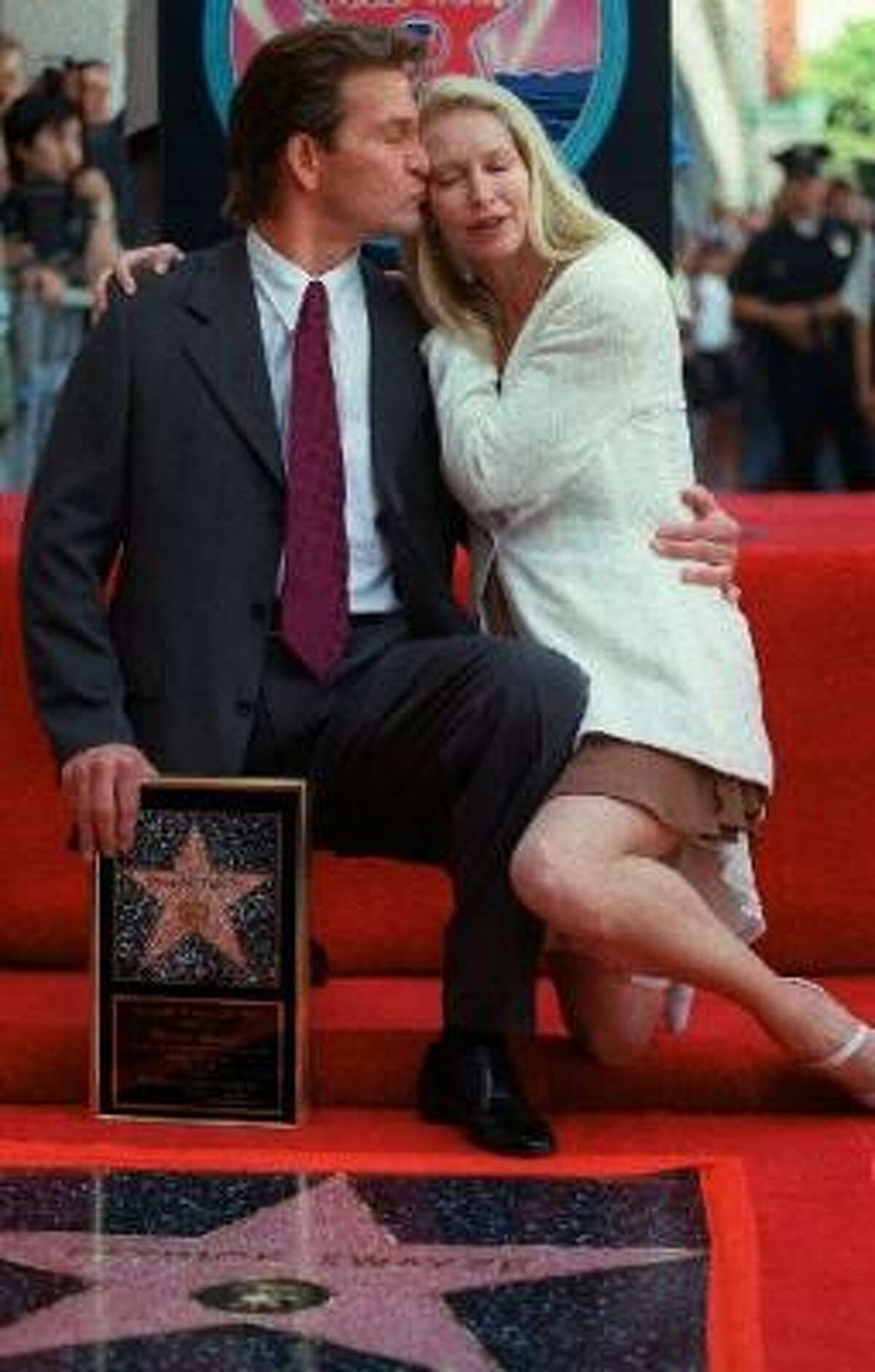 Swayze kisses his wife, Lisa, after the unveiling of his star on the Hollywood Walk of Fame in 1997.