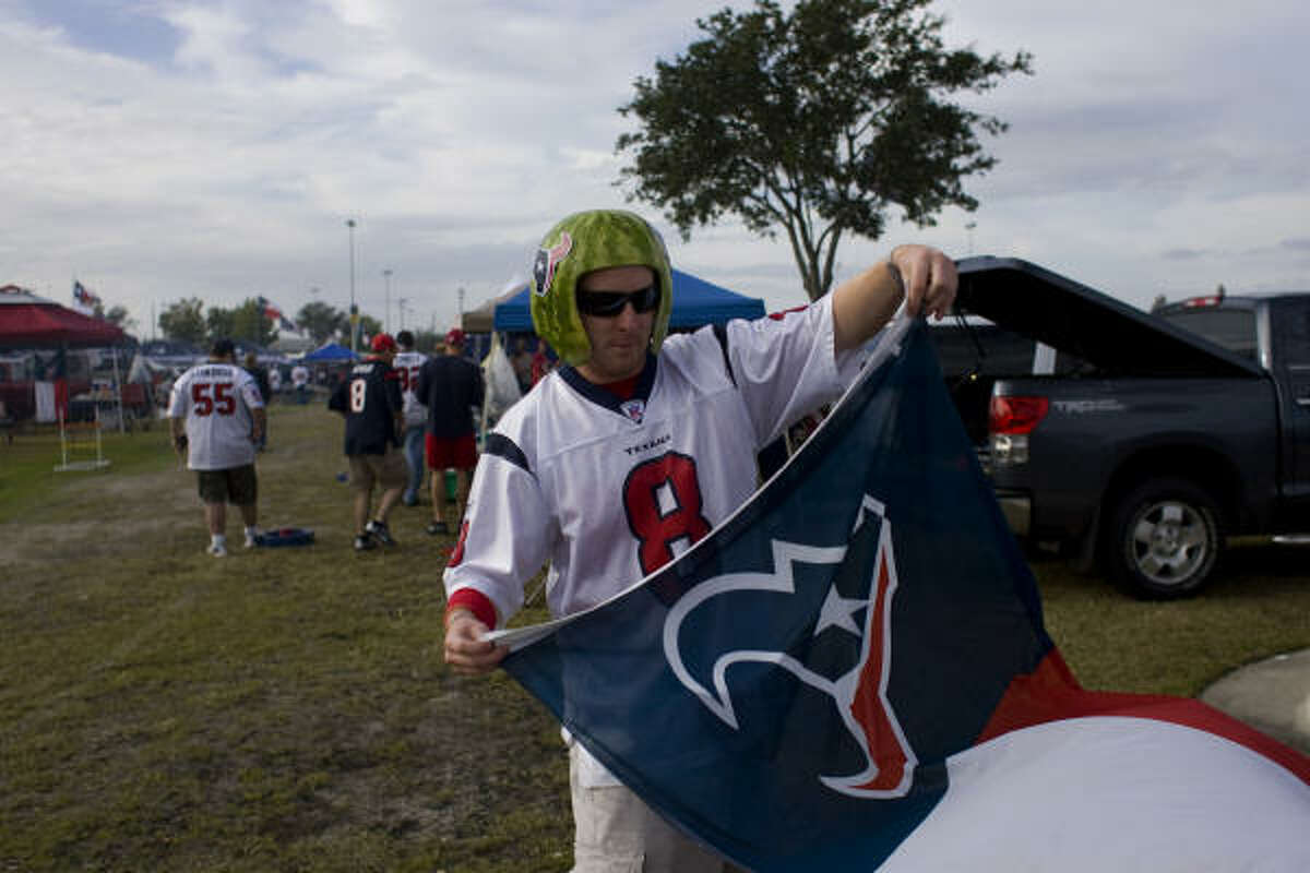Texans fan Rick Sweatt of Sugar Land prepares for the game against the Colts by wearing a watermelon helmet.