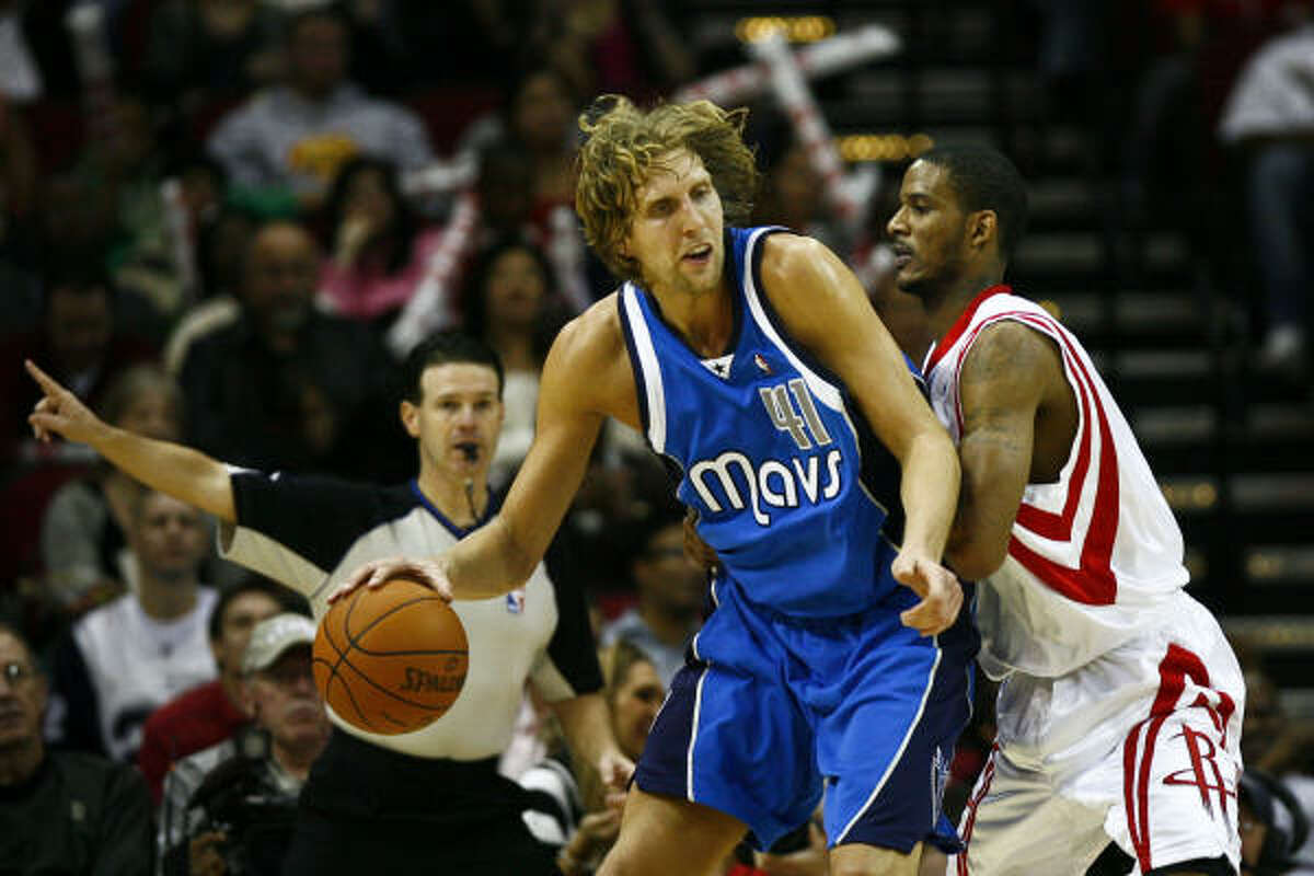 Trevor Ariza, right, and the Rockets had trouble containing Dallas forward Dirk Nowitzki, who scored 25 points in the Mavericks' 130-99 win Wednesday night at Toyota Center.