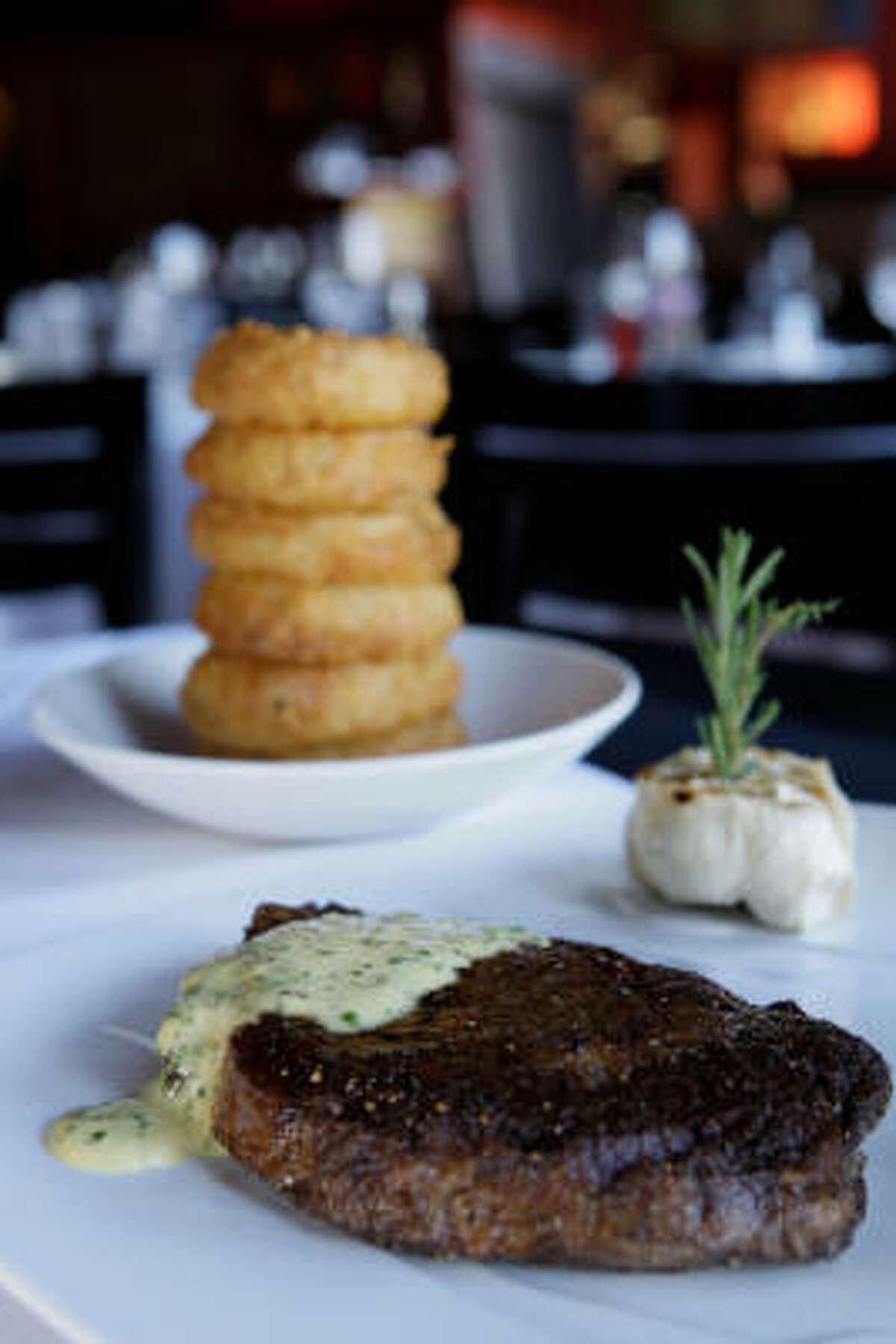Tesar's Grass-fed ribeye with bearnaise sauce and a whole half-bulb of roasted garlic and onion rings. 1701 Lake Robbins Drive, The Woodlands. Read more about Tesar's.