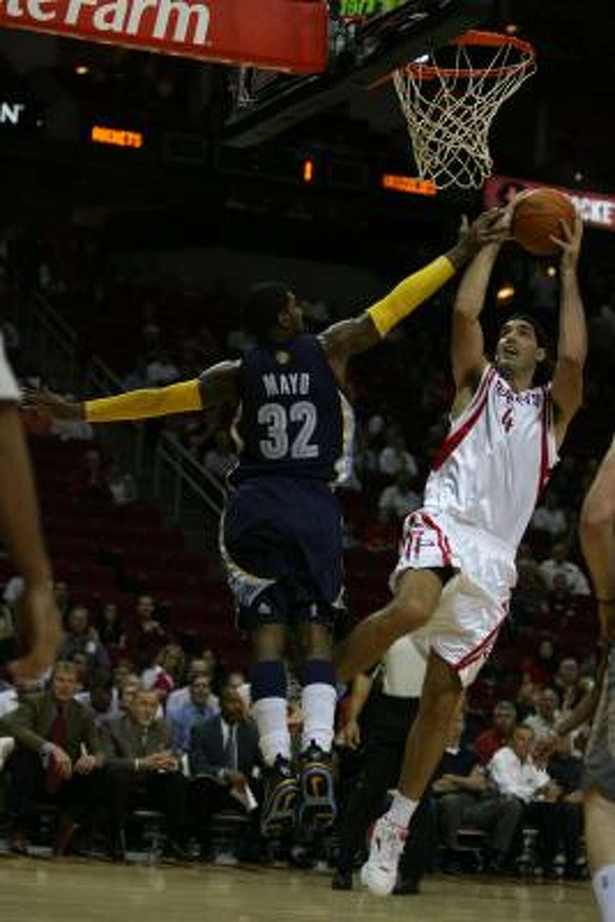 Grizzlies guard O.J. Mayo attempts to defend against Rockets forward Luis Scola out on a fast break to the basket during the first half.