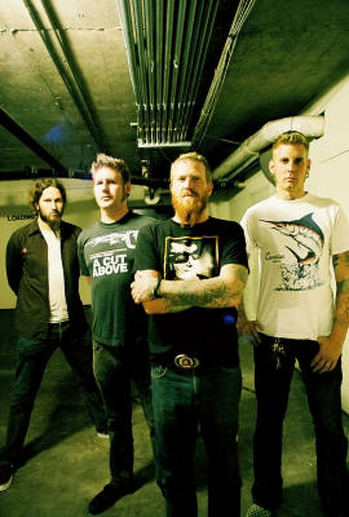 Mastodon's Brent Hinds (center) has a tattoo on his forehead.