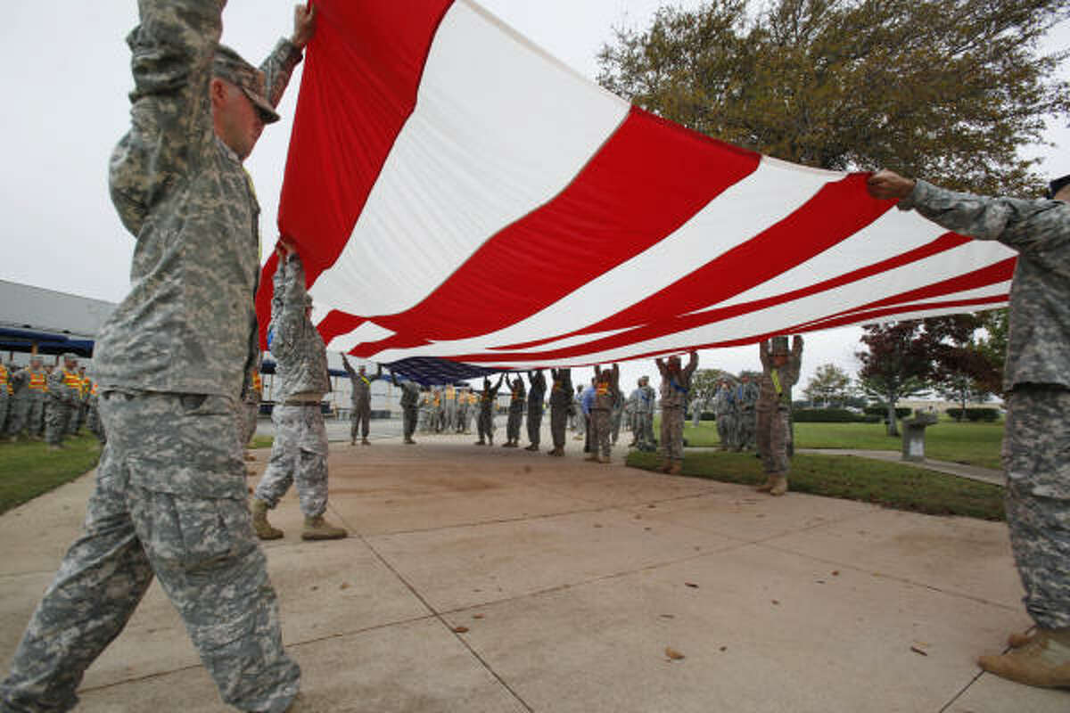 Soldiers from Fort Hood fold an American flag in November 2009 in preparation for President Obama's planned visit.