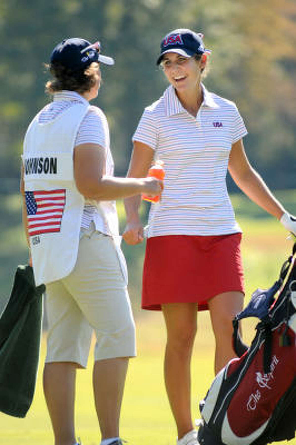 Jennifer Johnson, right,shares a laugh with her caddy, Alli Jarrett, while competing during the second round.