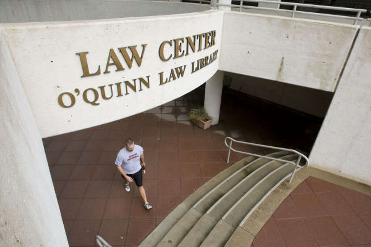 A student walks from the entrance of the John O'Quinn Library at the University of Houston Law School. The football field at the University of Houston's Robertson Stadium also is named for O'Quinn, a big UH supporter.