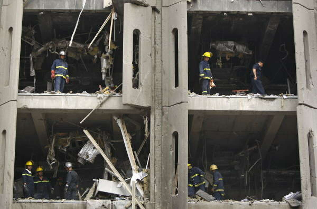 Iraqi firemen work at the scene of the damaged government offices.