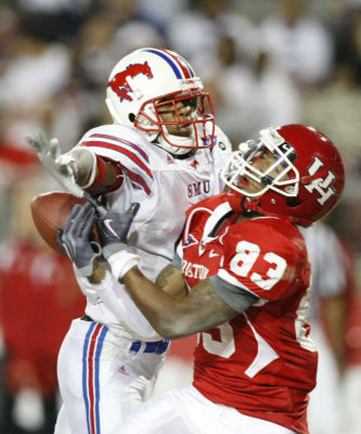 SMU cornerback Bryan McCann is called for interference as Houston wide receiver Patrick Edwards tries to make a play in the third quarter.