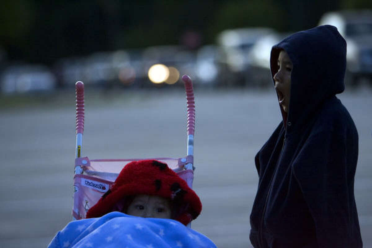 Samantha Rodriguez, 20 months old, and her brother Miguel Rodriguez, 4, of Conroe tried to stay warm as they waited to find out if their family would be able to receive the H1N1 vaccine.