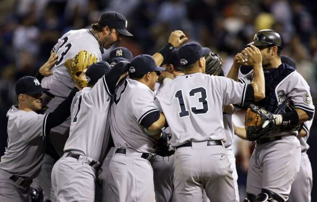 The Yankees celebrate after defeating the Twins 4-1 in Game 3 of the American League Division Series.