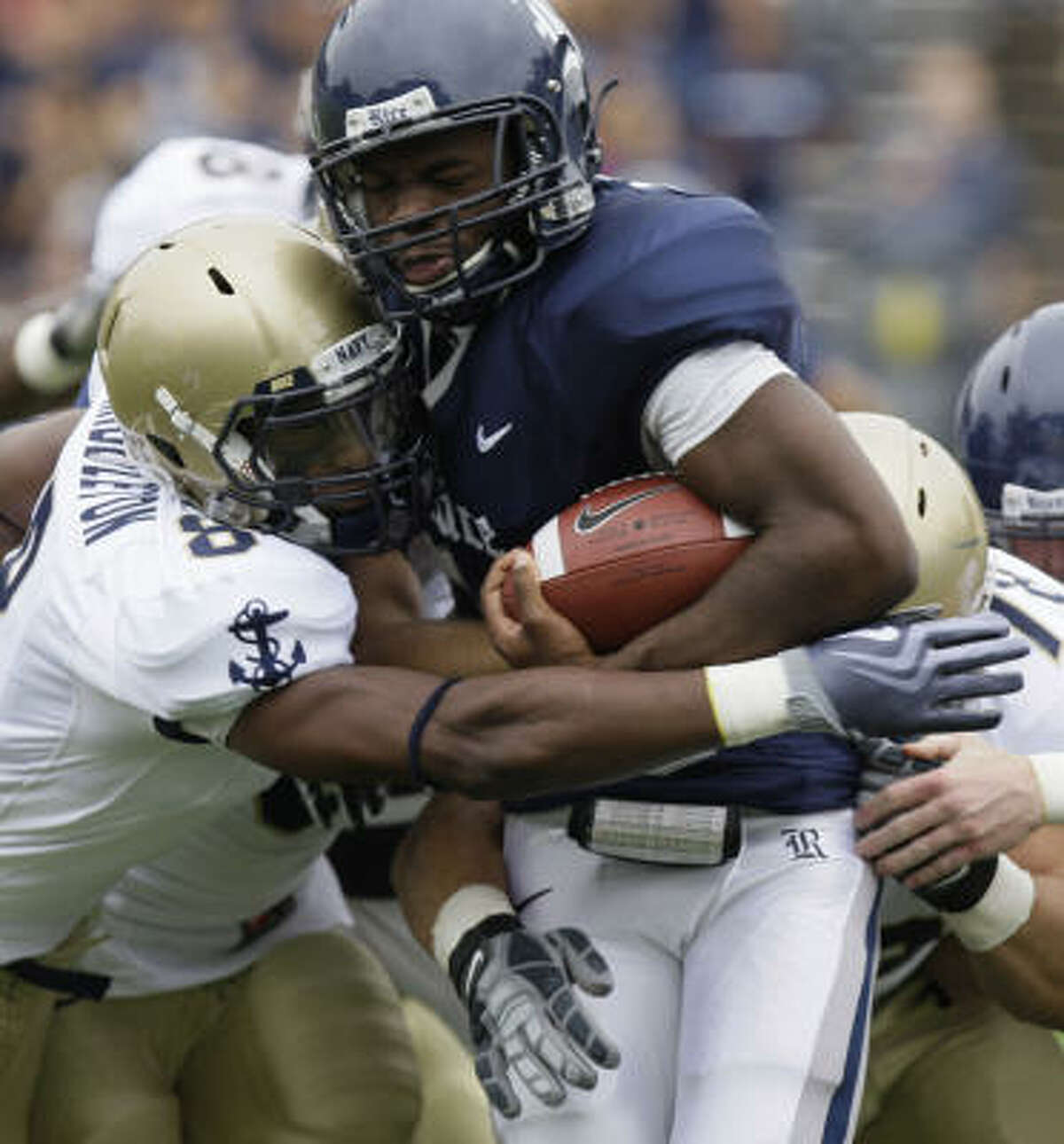 Rice's Charles Ross is stopped by Navy's Wyatt Middleton, left, and Michael Walsh during the first quarter of Saturday's game.