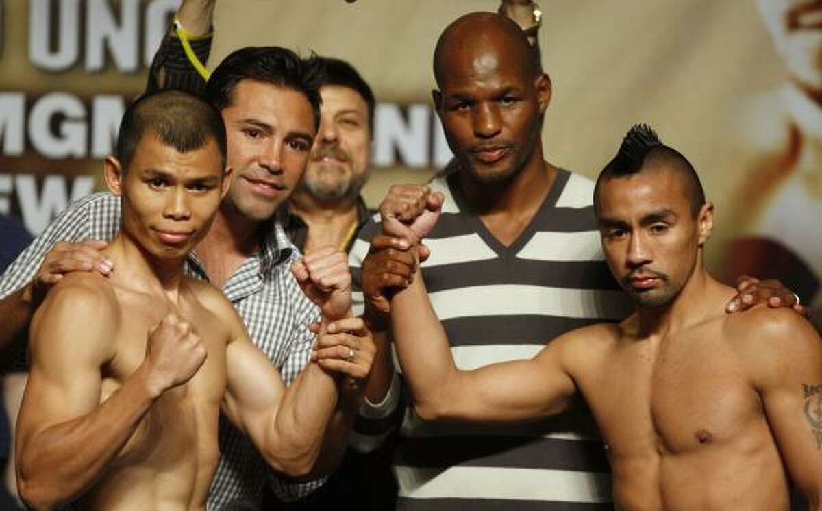 Houston's Rocky Juarez, right, will challemge Chris John for his WBO championship. Chris John, from Indonesia, poses with Oscar De La Hoya, behind John, and Bernard Hopkins, behind Juarez, were on hand for the weigh-ins.