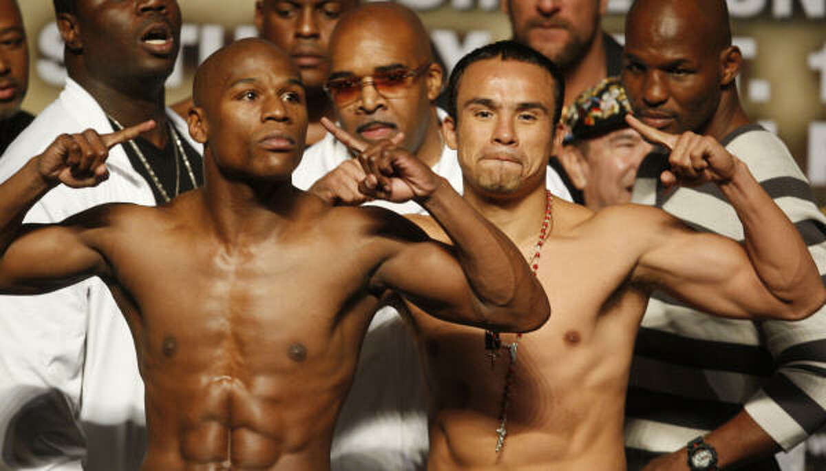 Floyd Mayweather Jr., left, and Juan Manuel Marquez pose during the official weigh-in for their non-title welterweight fight. For more on their fight, click here.